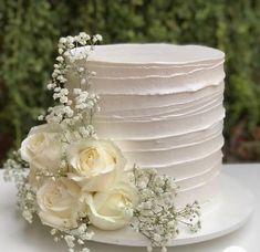 a white wedding cake with flowers on top