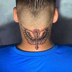 a man's neck with a cross and wings tattoo on the back of his head