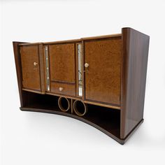 an art deco sideboard with two doors and three pipes on the bottom shelf,