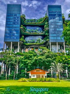 an unusual building with plants growing on it's sides in the middle of a park