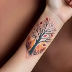 a woman's arm with a tree tattoo on it