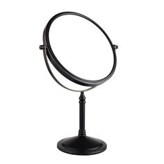 a round mirror sitting on top of a metal stand