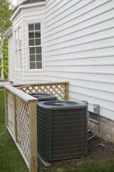 an air conditioner sitting on the side of a house