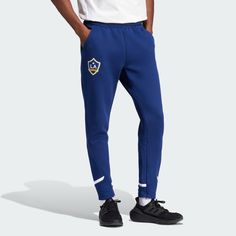 adidas Shop the LA Galaxy Designed for Gameday Travel Pants - Blue at adidas.com/us! See all the styles and colors of LA Galaxy Designed for Gameday Travel Pants - Blue at the official adidas online shop. Blue Sporty Sweatpants With Three Stripes Branding, Sporty Blue Sweatpants With Three Stripes Branding, Sporty Blue Joggers With Three Stripes Branding, Adidas Three Stripes Bottoms For Sports Events, Casual Sports Bottoms With Three Stripes, Casual Three Stripes Bottoms For Sports Events, Blue Sports Joggers With Three Stripes Branding, Blue Sports Joggers With Three Stripes, Blue Joggers With Three Stripes Branding For Sports