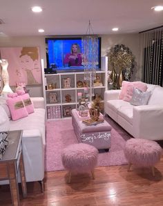 a living room filled with white furniture and pink rugs