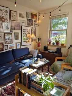 a living room filled with furniture and lots of pictures on the wall next to a window