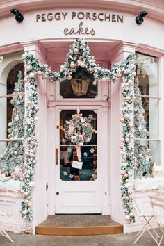 a pink store front decorated with christmas decorations