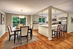 a kitchen and dining room with hardwood floors