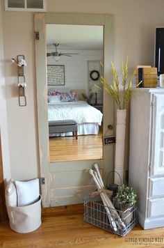 a white refrigerator freezer sitting next to a wooden floor