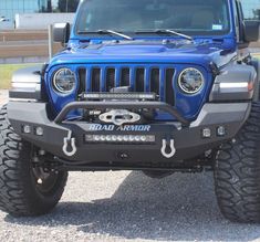 a blue jeep parked in a parking lot