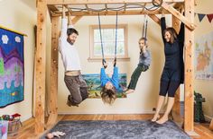 three people hanging upside down in a room