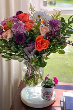 a vase filled with flowers sitting on top of a table