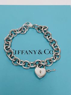 Authentic TIFFANY&Co chain link bracelet with heart and key lock removable charm in Sterling Silver. .Lock opens and closes. Marked : TIFFANY&Co.925.Condition: PRE-OWNED/ Sterling Silver shows some sight of wear.This Item does not come with original TIFFANY&Co box/pouch. Tiffany’s Charm Bracelet, Tiffany And Co Lock Bracelet, Tiffany And Co Heart Tag Bracelet, Tiffany Lock Bangle, Tiffany And Co Heart Lock Necklace, Tiffany And Co Box, Pandora Bracelet Charms Ideas