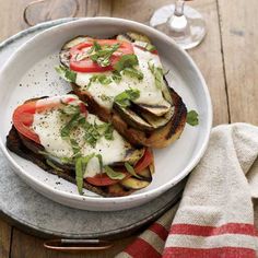 two grilled eggplant sandwiches with tomatoes and sour cream on toasted bread