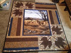 a quilt is laying on the floor in front of a chair and table topper