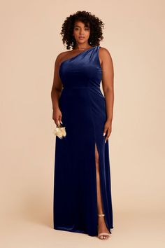 a woman in a long blue dress with one side slited and an asymmetrical neckline