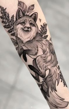 a black and white tattoo with a fox on it's arm