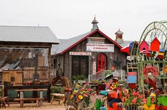 an assortment of colorful garden items in front of a building