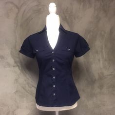 Express Essential Stretch Navy Blue Button Up Buckle Short Sleeve Blouse Nwot Size: Xsmall Shop With Confidence! Clean And Smoke Free Home And Boutique! Ships Same Day Or Next Business Day! All Items Are Handled And Shipped With Tlc! Collared Shirts Women, Blue Button Up, Short Sleeve Button Down Outfit, Princess Diaries Costume, Organized Clothes, Hotel Closet, Fitted Button Up Shirt, Blue Work Shirt, Navy Outfits