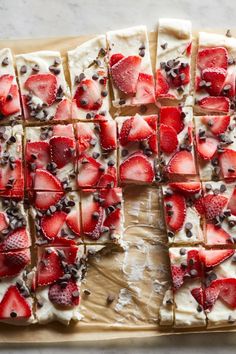 sliced strawberries and chocolate on top of a cookie sheet