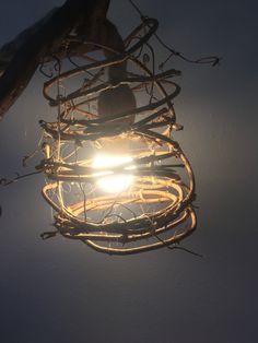 a light that is hanging from the ceiling with wires attached to it's sides