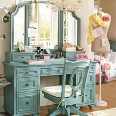 a bedroom with a vanity and mirror in it