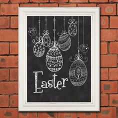 a chalkboard with some ornaments hanging from it's side on a brick wall