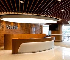 an office lobby with a curved reception desk