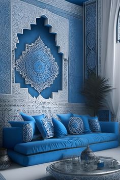 a blue couch sitting in front of a wall covered in intricately designed paper work