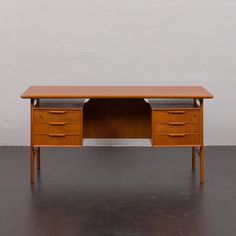 a wooden desk with three drawers on it