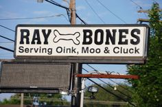 a sign for ray bones serving oink, moo and cluck