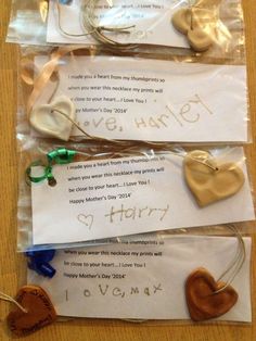 three pieces of paper with hearts attached to them and some words on the envelopes