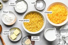 ingredients for macaroni and cheese laid out in bowls