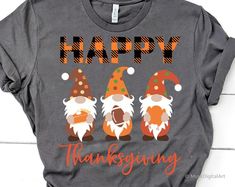 a gray shirt with three gnomes on it and the words happy thanksgiving written in orange