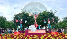 the entrance to spaceship land at disney's animal kingdom is decorated with colorful flowers and decorations