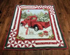 an old red truck with christmas decorations on it's bed quilted onto the floor