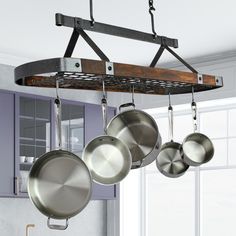 pots and pans hanging from a rack in a kitchen