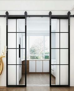 an open living room with sliding glass doors and wood flooring, along with a painting on the wall