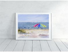 a painting of an umbrella on the beach in front of a white wall and wooden floor