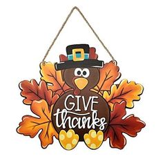 a sign that says give thanks with a turkey wearing a pilgrim hat