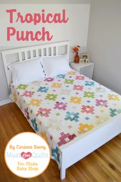 there is a bed with a colorful quilt on it and the words tropical punch above it