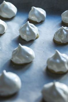 there are many cookies with white icing on the cookie sheet