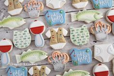 decorated cookies are arranged on a wooden table with the words baby's and fish