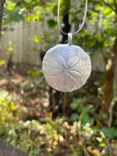 Sand Dollar Pendant Made from a sand dollar found on a  beach walk.                      .༺ ༻. This sand dollar is made entirely in house, from its casting, to the final polish. Made in PEI, Canada Available in Sterling silver or bronze Ships gift-ready Pei Canada, Sand Dollar Necklace, Sand Dollar Pendant, Backyard Studio, Sand Dollar, Beach Walk, Personalized Card, Small Backyard, Silver Fashion