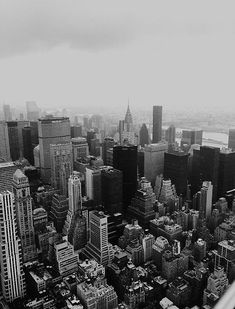 black and white photograph of city buildings in new york, ny taken from the empire building