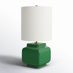 a green table lamp with a white shade