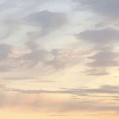 two airplanes are flying in the sky at sunset or dawn, with clouds above them