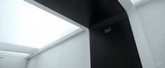 a black and white photo of a room with a skylight in the ceiling above it