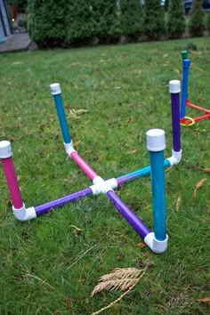 an outdoor game set up in the grass with plastic tubes and sticks sticking out of it