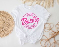 a t - shirt that says come on barbie let's go party with pink lettering